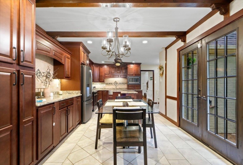 Dining space featuring recessed lighting, french doors, beam ceiling, a notable chandelier, and light tile patterned flooring