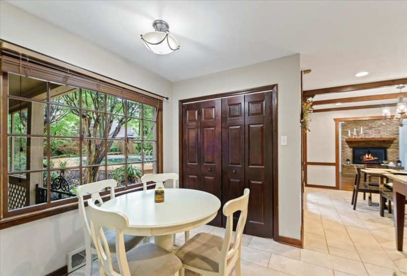 Dining space with recessed lighting, light tile patterned floors, a brick fireplace, baseboards, and visible vents