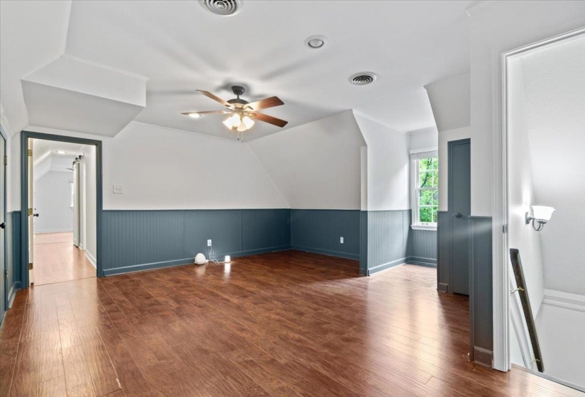 Bonus room with a ceiling fan, visible vents, wood finished floors, and baseboards