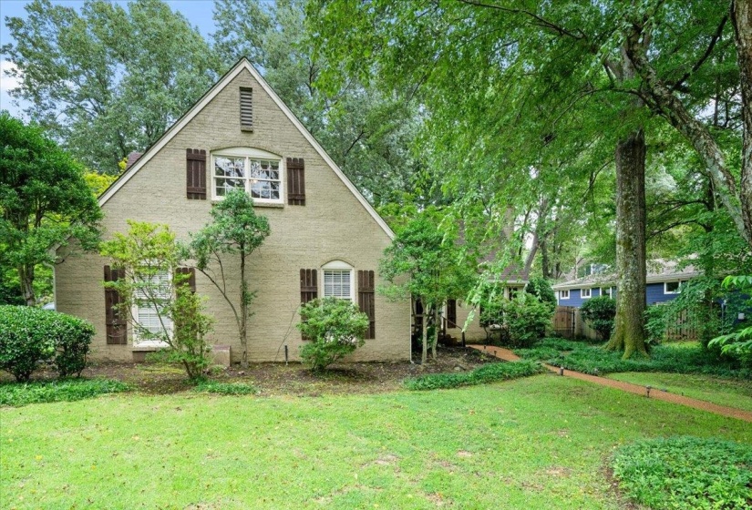 View of property exterior with a yard