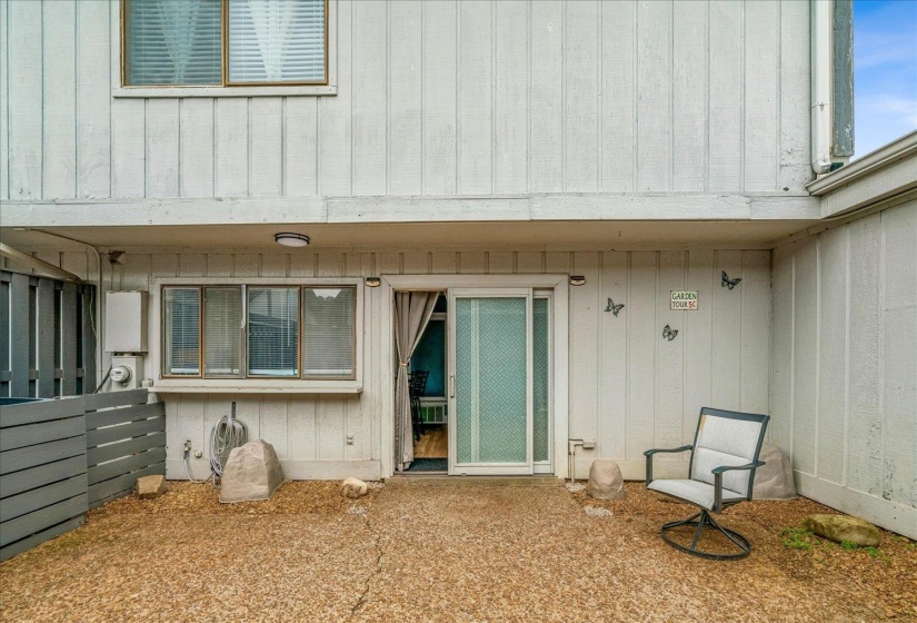 Ground-level patio with a textured gravel surface