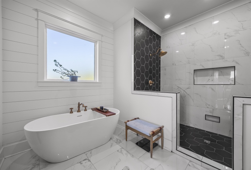 Freestanding soaking tub with brass fixtures