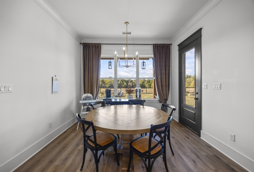 Spacious room featuring wood-finish flooring and white walls
