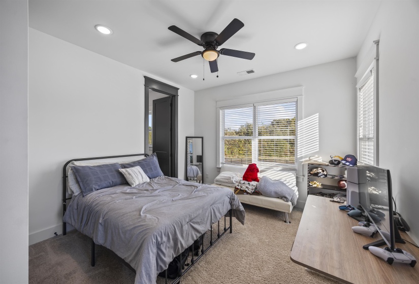 Bright room with neutral wall paint and plush carpet flooring
