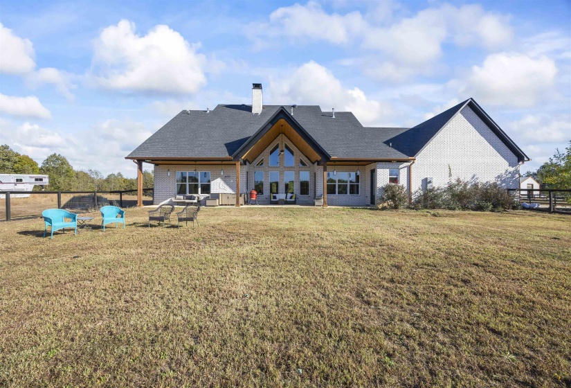 Ranch-style residence featuring a prominent gabled roofline and light-colored brick exterior