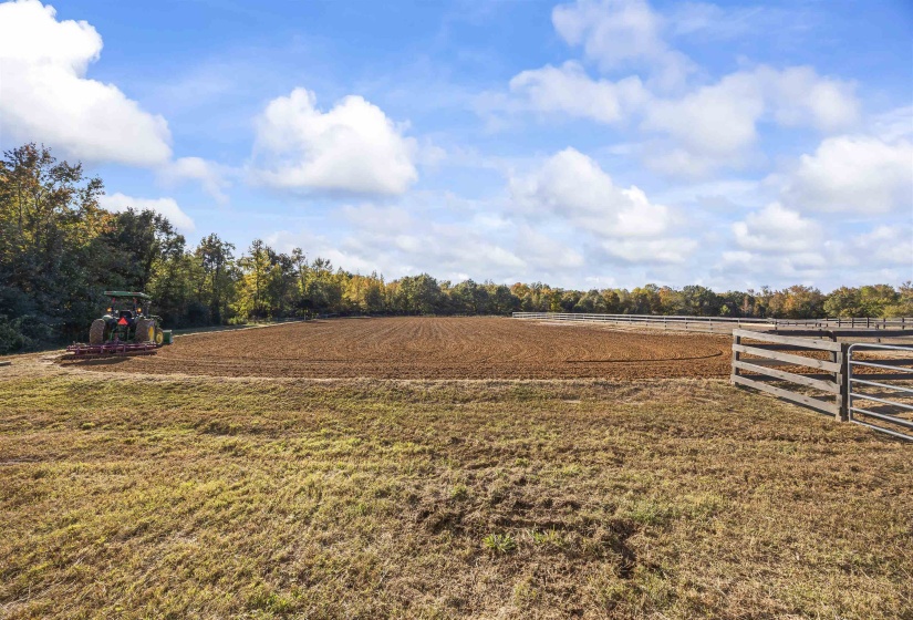 Large open field with surrounding natural fencing
