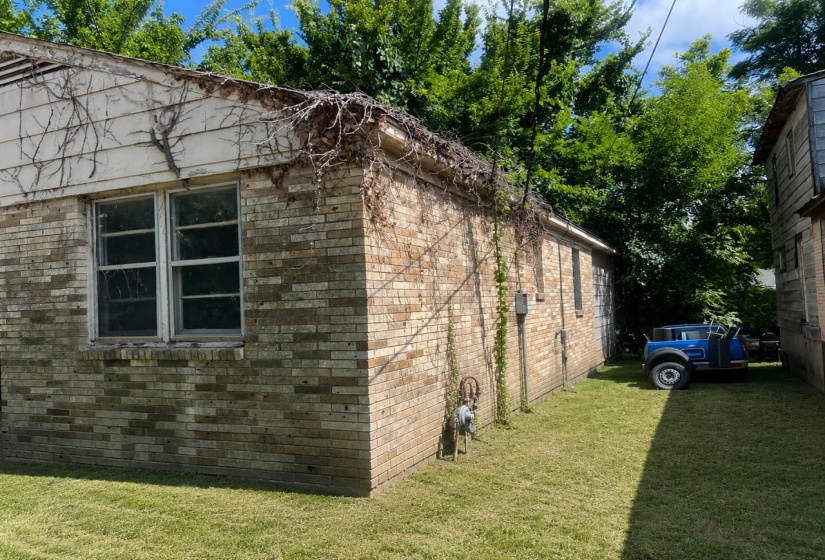 Brick exterior with white siding accents and multiple windows