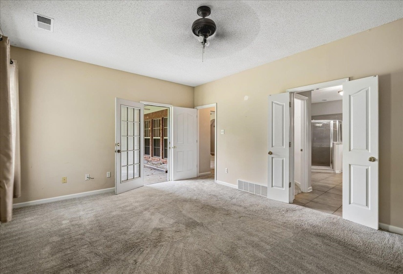 Carpeted interior space featuring neutral wall tones and a ceiling fan
