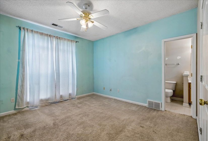 Carpeted room featuring a ceiling fan with integrated lighting