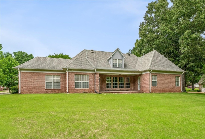 Brick exterior with a gabled roofline, multiple windows, and a dormer