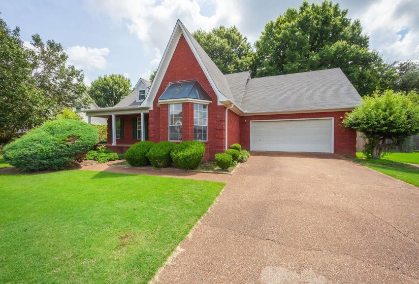 Red brick exterior with a prominent bay window and white trim details