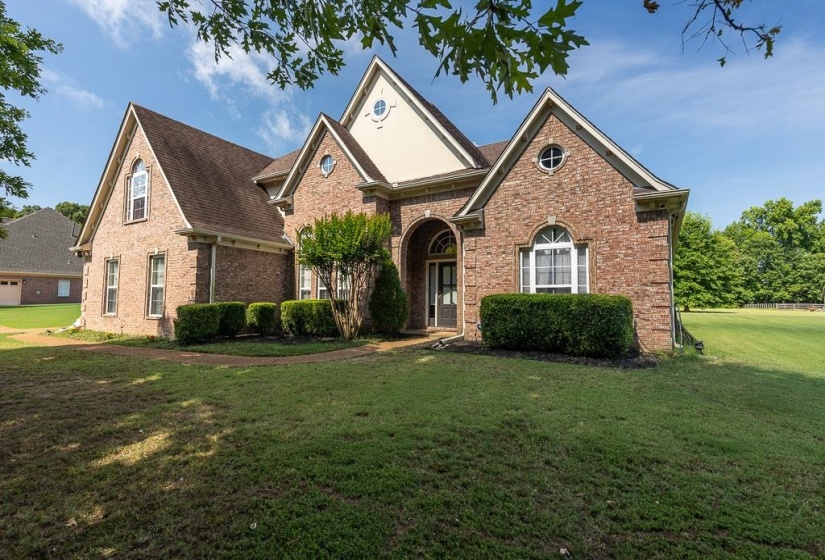 Brick exterior with gabled roof lines and arch-top windows