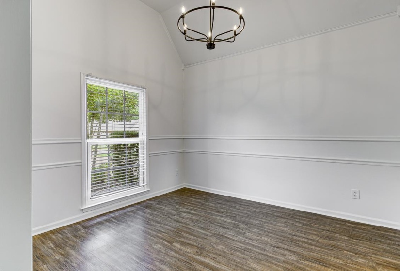 Vaulted ceiling featuring a contemporary chandelier