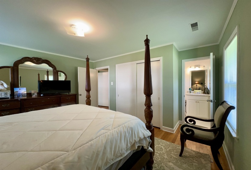 Bedroom with wood-finish flooring, two sliding closet doors, and recessed lighting