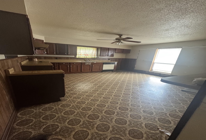 Kitchen featuring extensive cabinetry, patterned flooring, and a ceiling fan