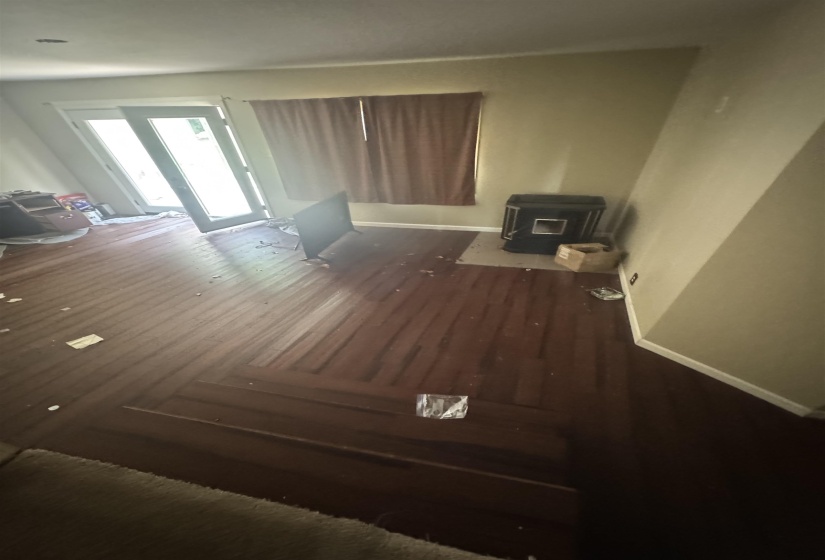 Wood-finish flooring throughout, featuring a dark stain and a visible grain pattern