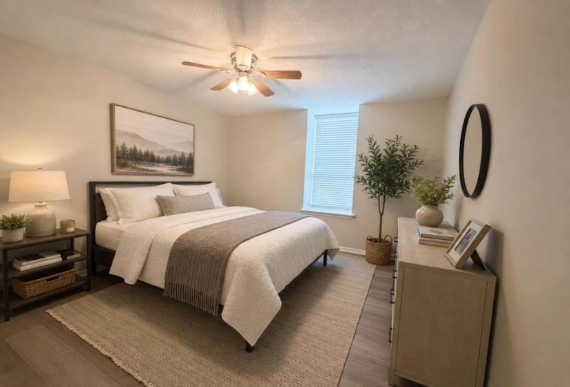 Guest Bedroom featuring wood-finish flooring, a ceiling fan with integrated lighting, and neutral wall