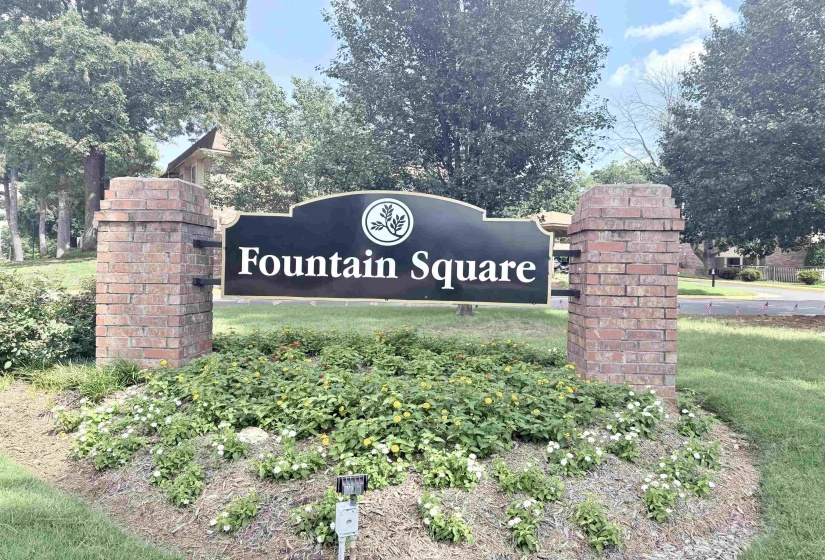 Fountain Square community entrance sign with brick columns, set amidst a landscaped bed