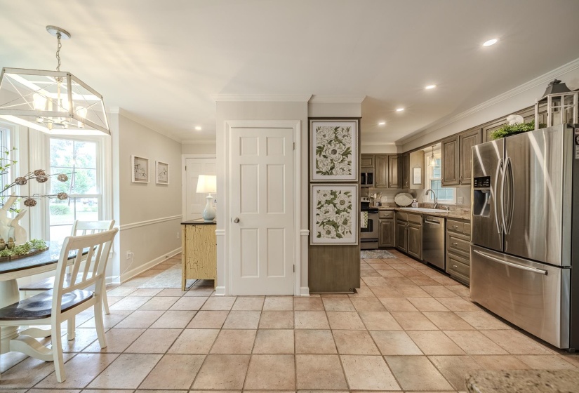 Open-concept kitchen and dining area featuring tile flooring, recessed lighting, and a modern light fixture