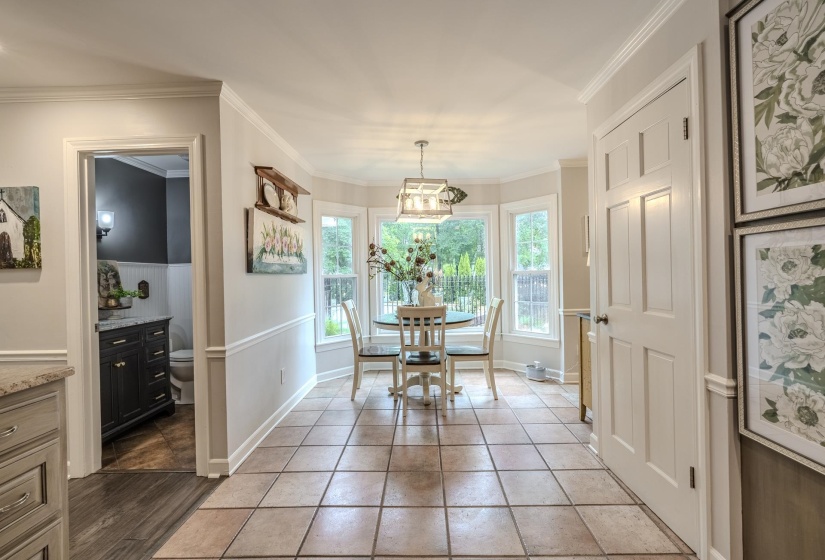 Dining nook featuring a bay window, tile flooring, and a decorative light fixture