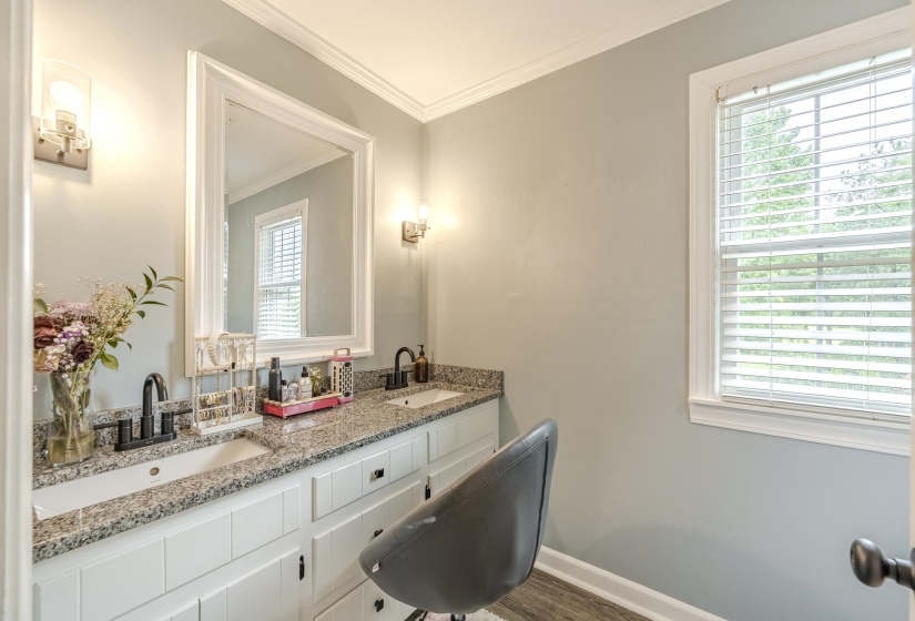 Double vanity featuring granite countertops, undermount sinks, and matte black fixtures