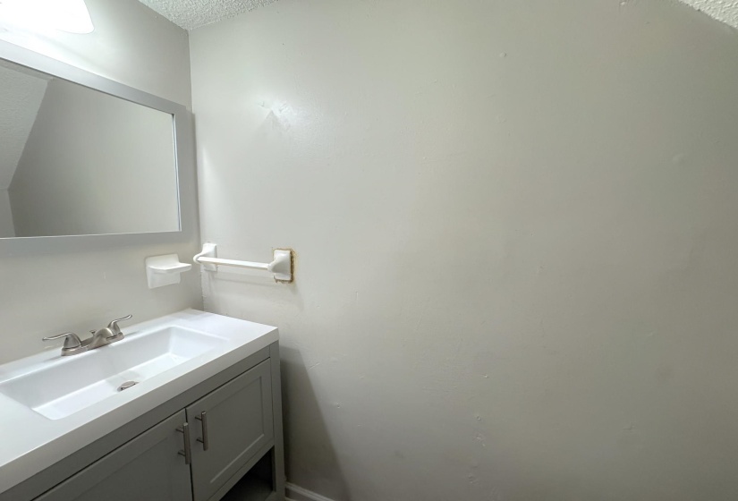 Contemporary vanity featuring a white integrated sink and countertop
