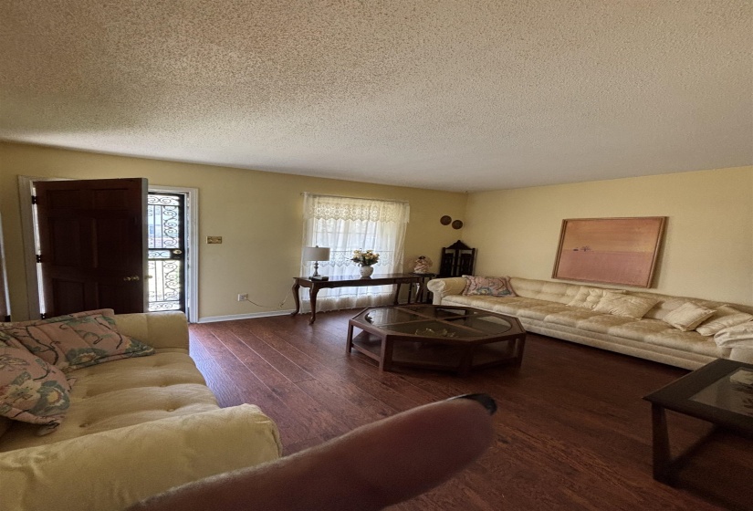 Living area with wood finished floors and a textured ceiling