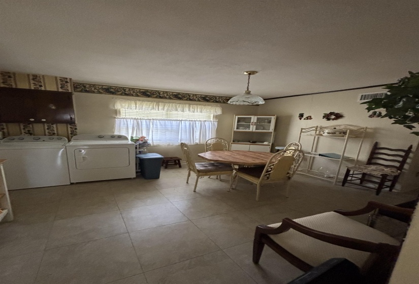 Dining room featuring tile patterned floors and separate washer and dryer