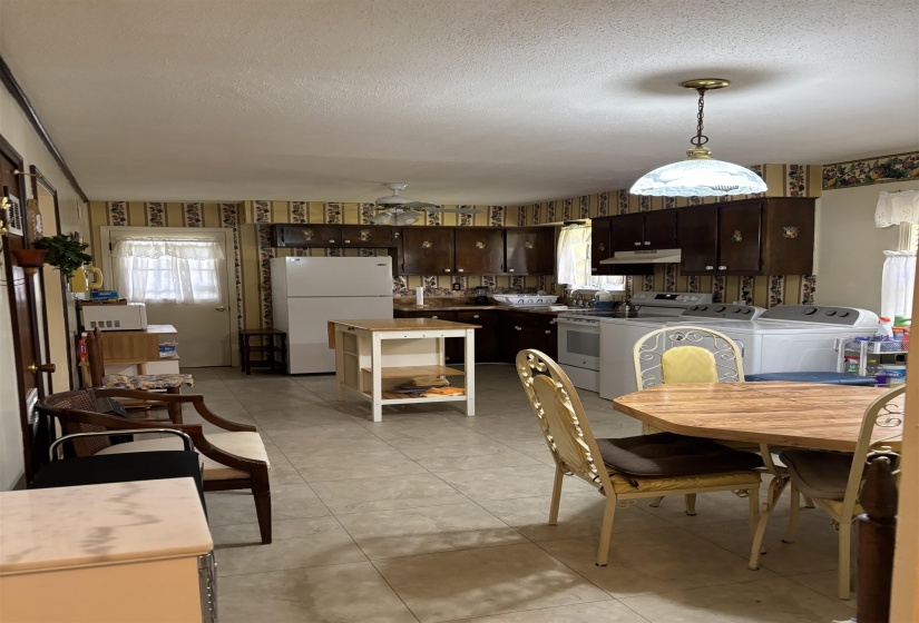 Dining area featuring a textured ceiling and ceiling fan