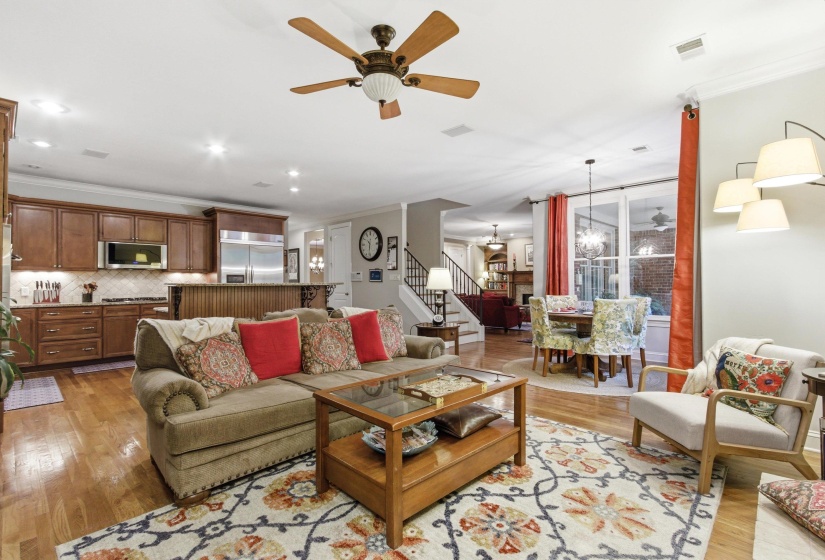 Open concept living area featuring hardwood flooring, recessed lighting, and a five-blade ceiling fan