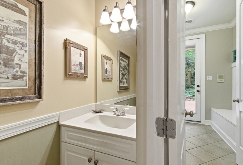 Bathroom vanity featuring a white cabinet, integrated sink, and light-toned countertop