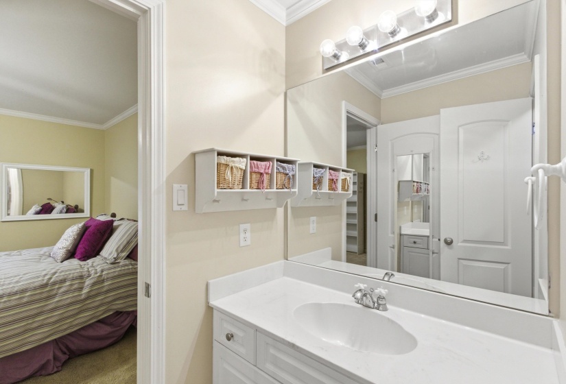 Bathroom vanity with an integrated sink, white countertop, and chrome faucet