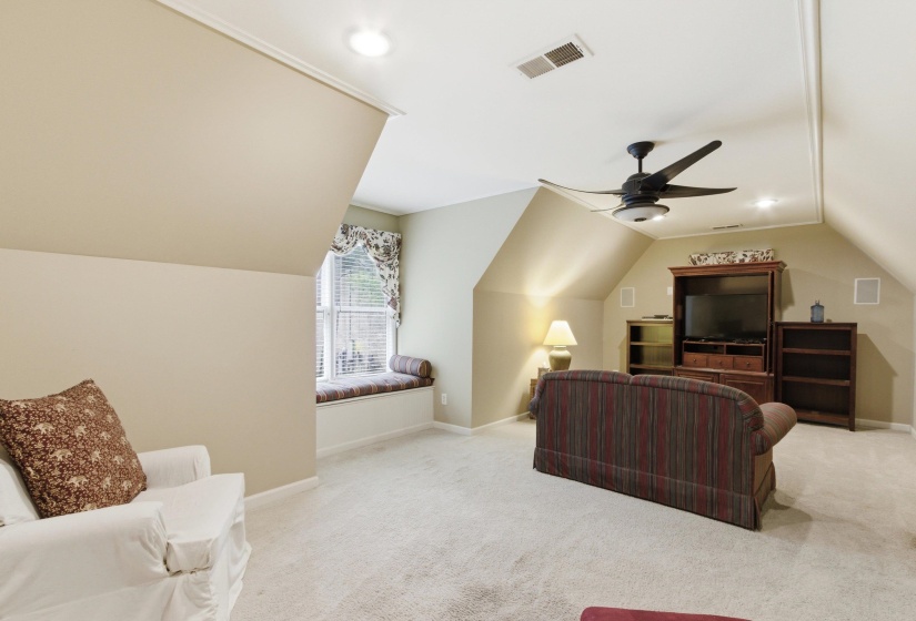 Carpeted bonus room featuring a window seat with blinds, sloped ceilings, recessed lighting, and a ceiling fan