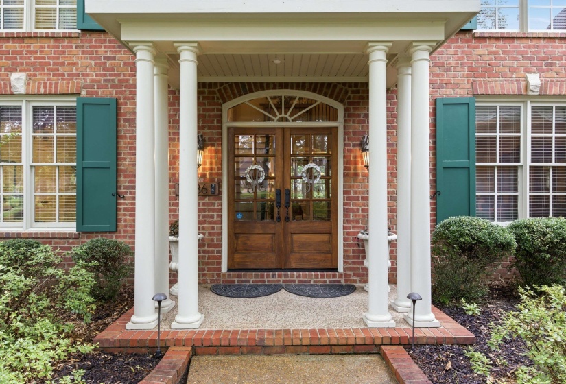 Brick facade with white columned portico