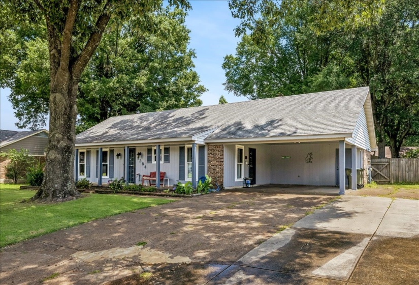 Ranch-style residence featuring a carport, a front porch with supporting columns, and a concrete driveway