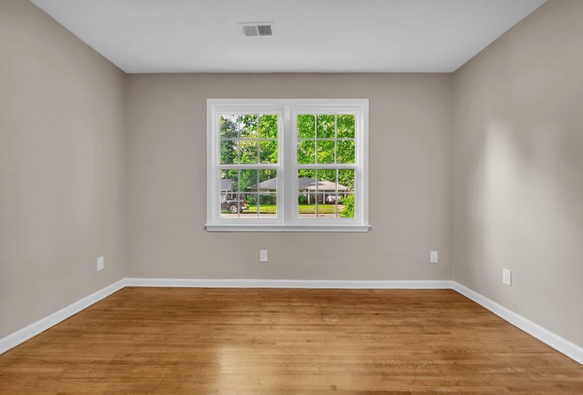 Neutral tone walls with white trim and wood-finish flooring