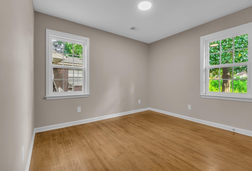 Hardwood flooring, painted walls, white trim, recessed ceiling light, and double-hung windows