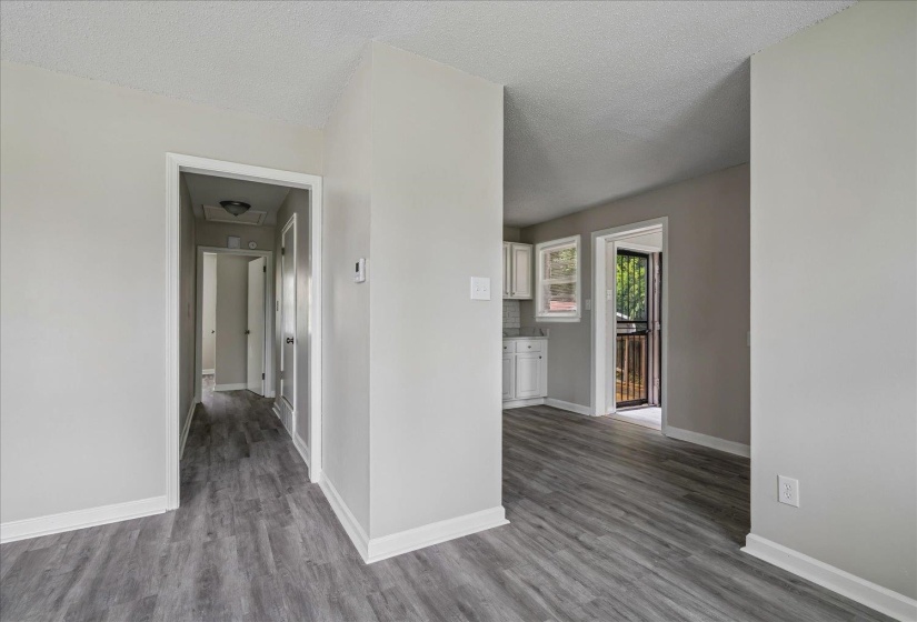 Entryway featuring wood-finish flooring, light gray walls, white trim, and a flush mount ceiling light