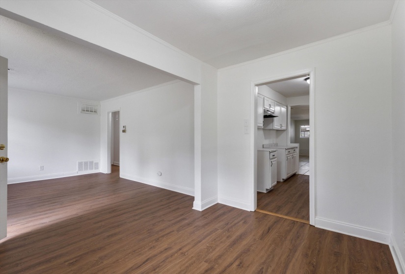 Spacious interior featuring wood-finish flooring, white walls, and bright white trim