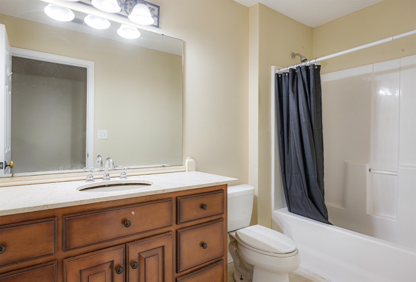 Bathroom featuring vanity and shower / bath combo