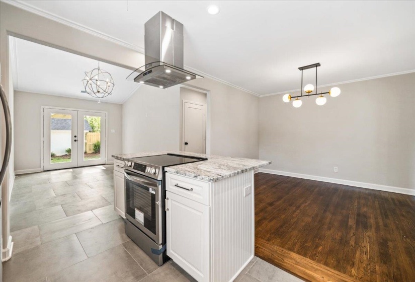 Kitchen island with a stainless steel range and granite countertop