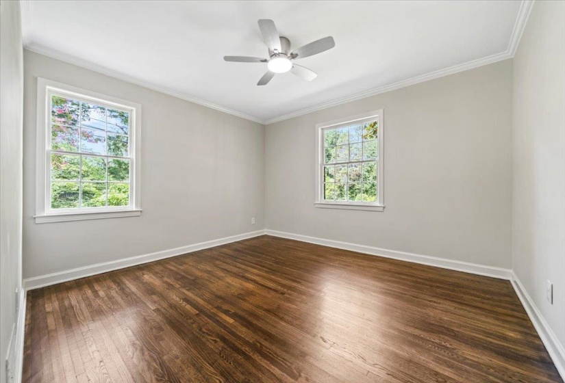 Hardwood flooring, painted walls, and crown molding