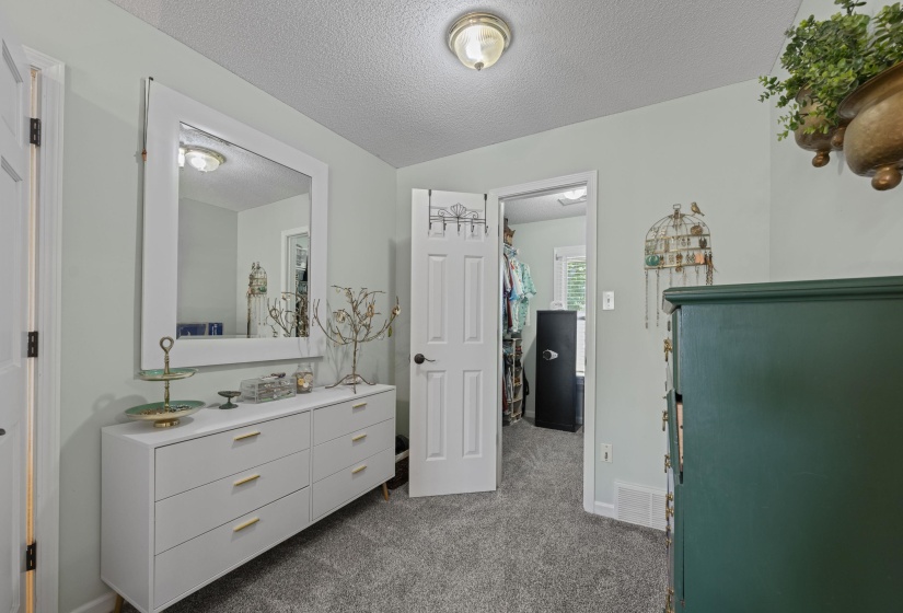 Light-colored walls with textured ceiling and wall-mounted light fixture