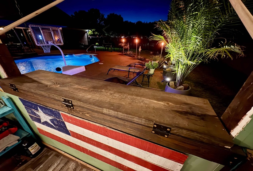 Outdoor bar with a dark wood-finish countertop