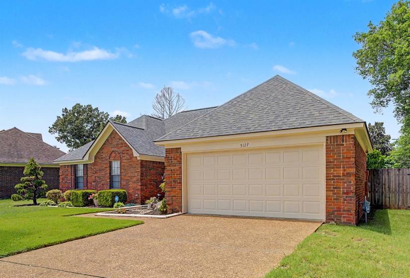Brick exterior with a gabled roof and attached two-car garage