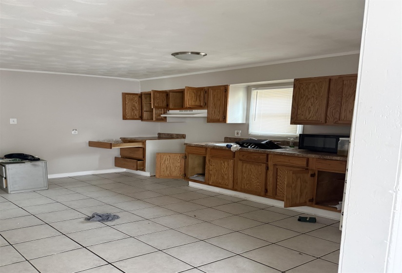 Kitchen featuring wood-finish cabinetry and a tiled floor