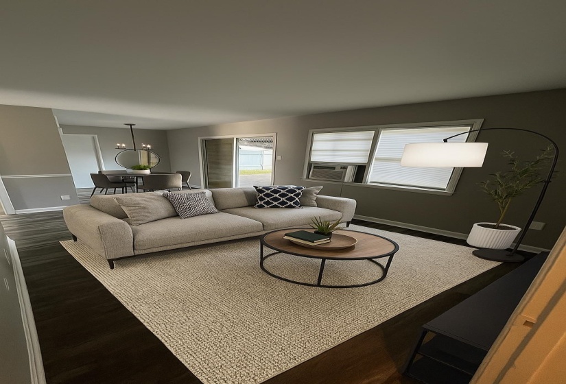 Living area with wood finished floors and a chandelier