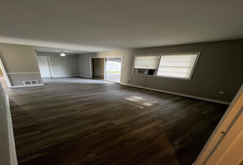 Spare room featuring dark wood-style floors and a ceiling fan