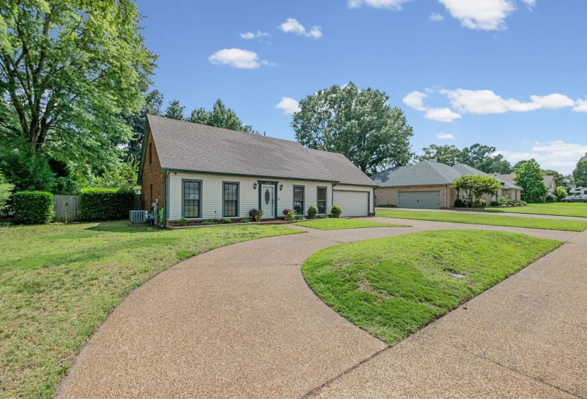 Traditional-style residence with light-colored siding and a dark-toned roof