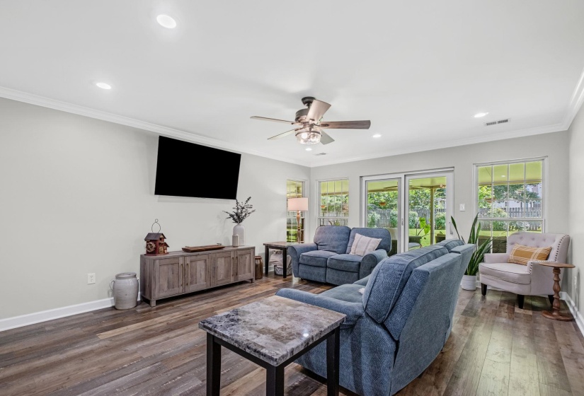 Living area featuring wood-finish flooring, recessed lighting, and a ceiling fan